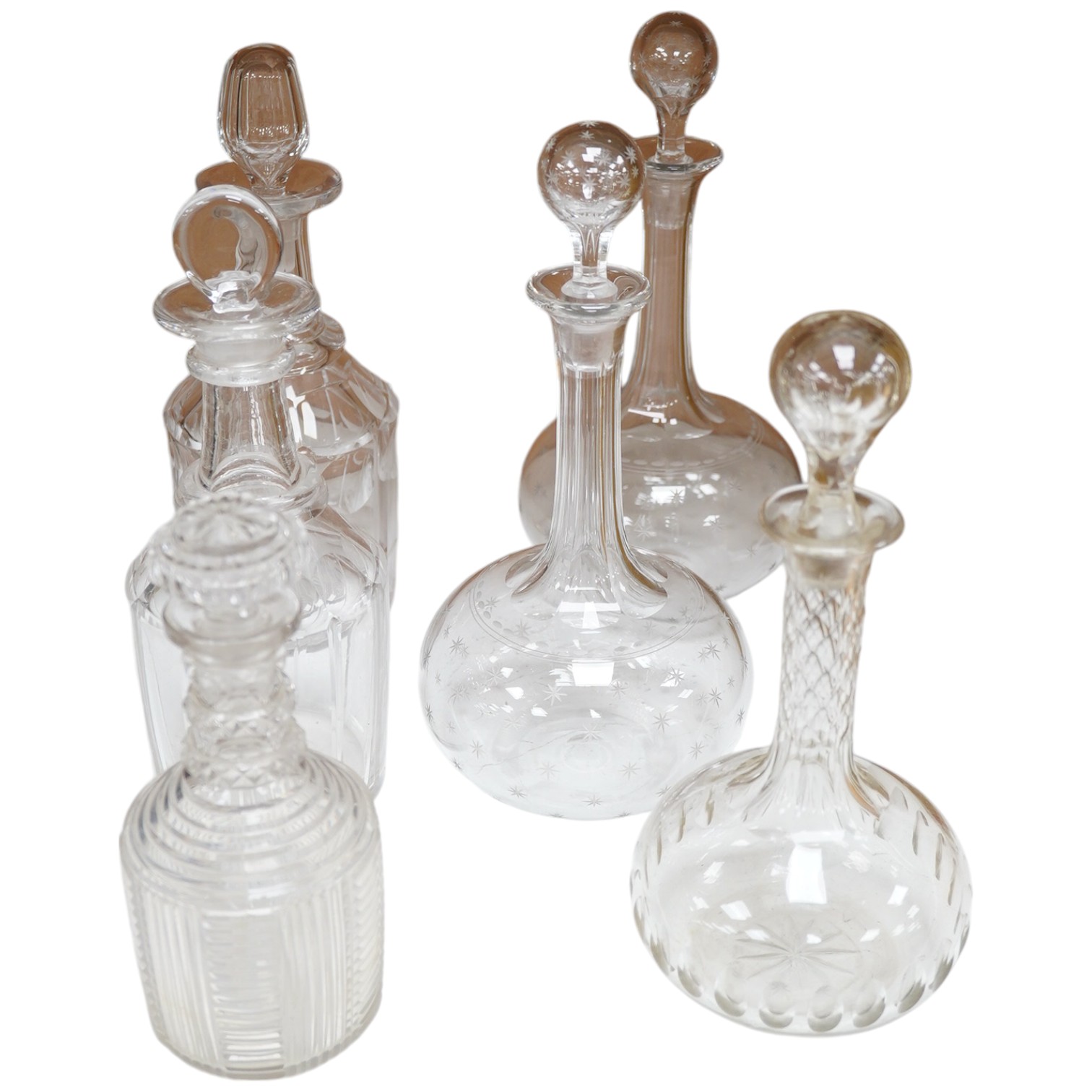 Six late 19th century and early 20th century cut glass decanters, including a pair of decanters with engraved star decoration, and four others. Condition - good